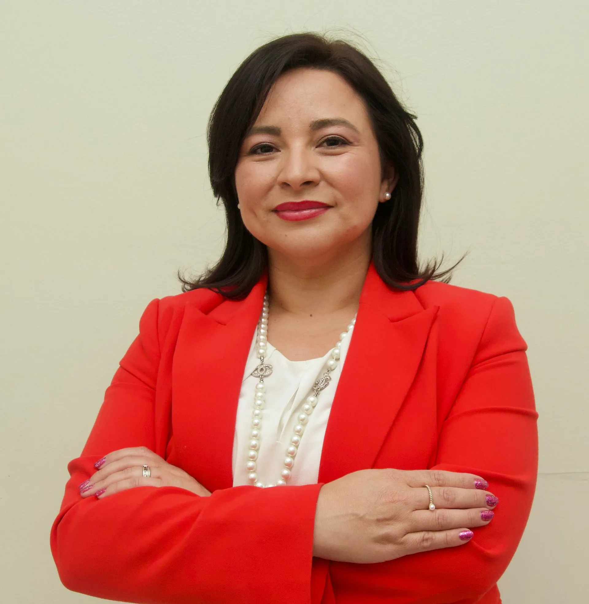 Melva Vazquez, founder of Brighter Day Realty, in a red blazer
